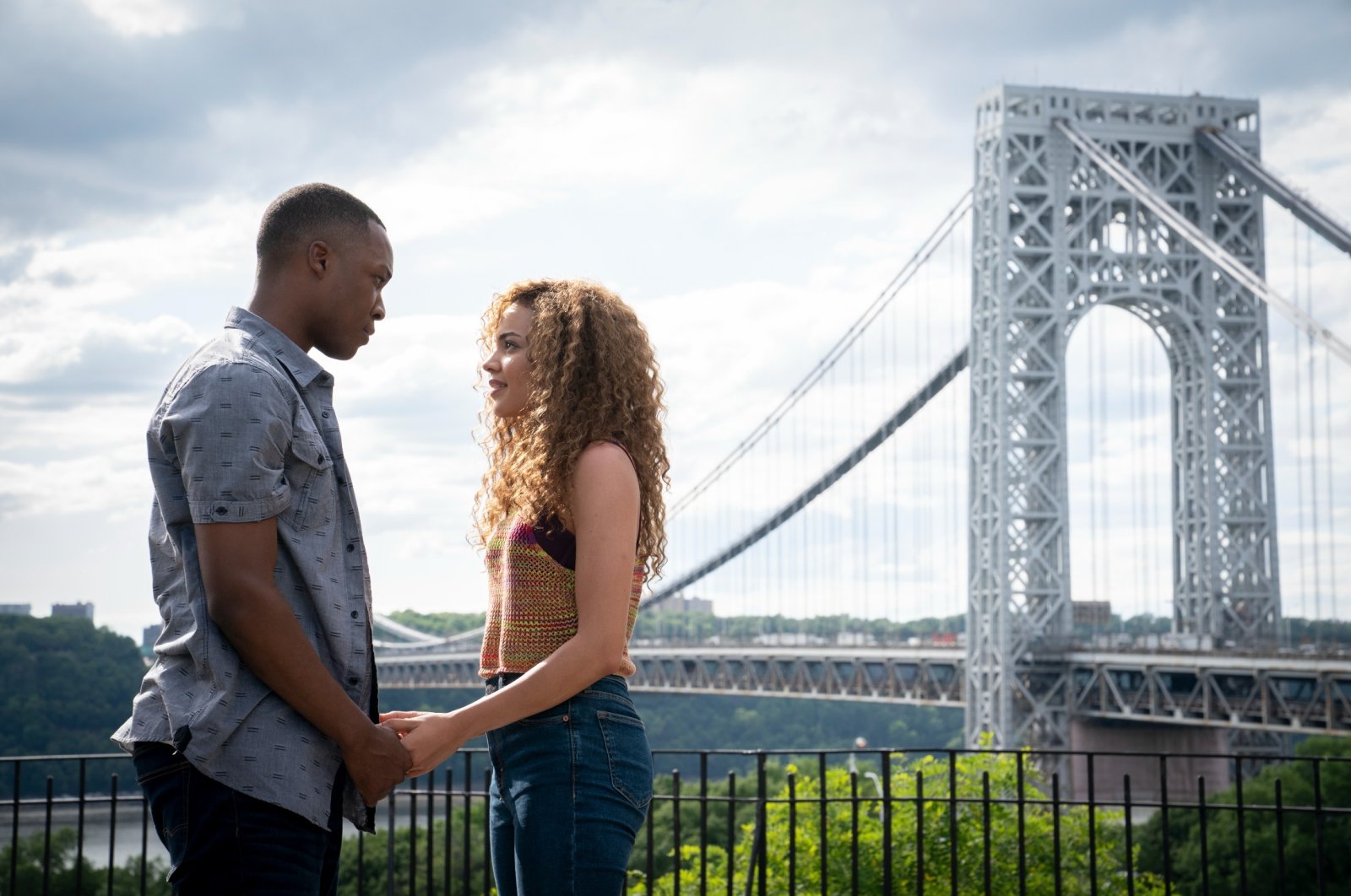 Corey Hawkins (L) and Leslie Grace hold hands in a scene from the musical film "In the Heights." (Warner Bros. via AP)
