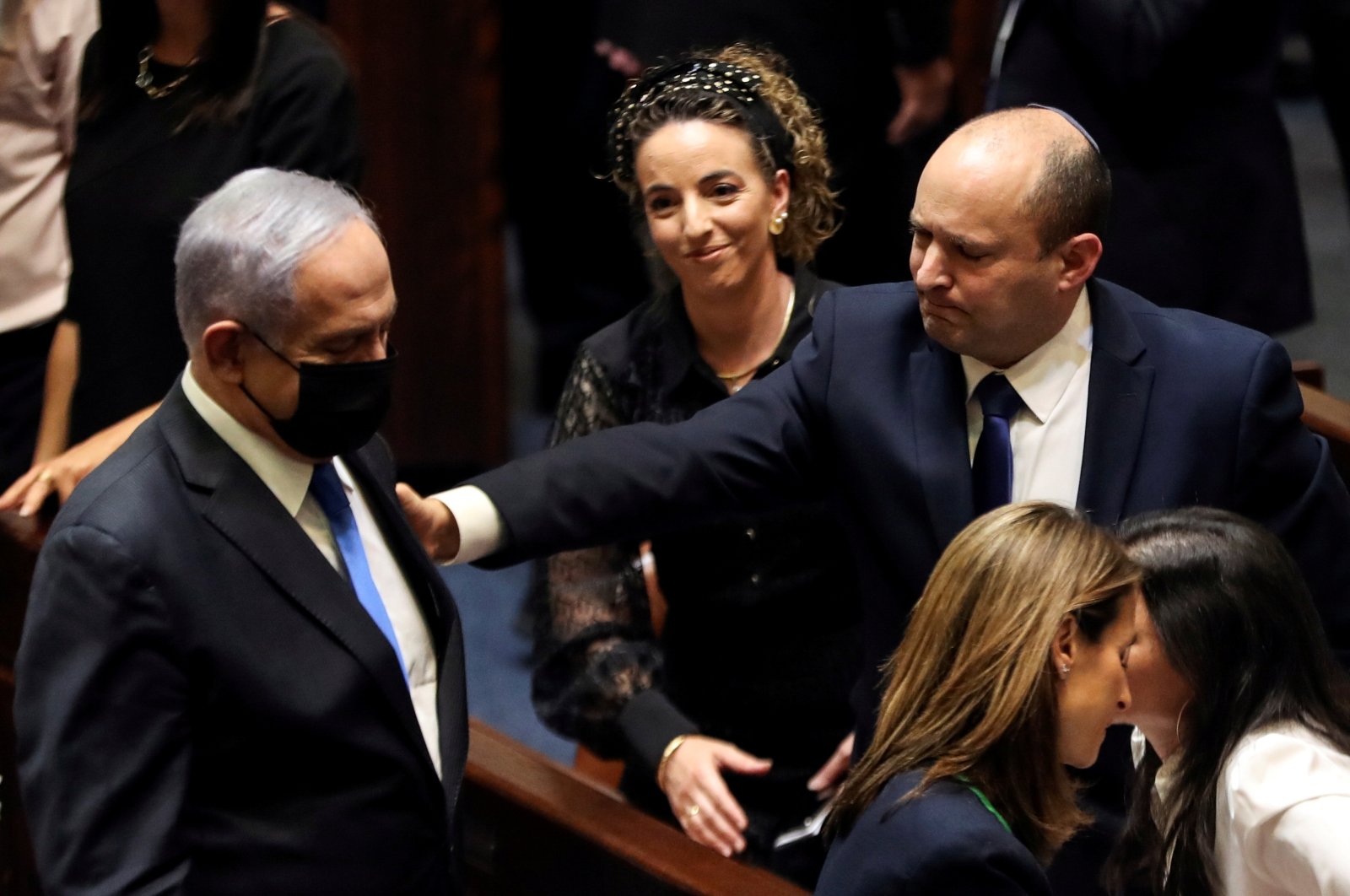 Former Prime Minister Benjamin Netanyahu (L) and Israel Prime Minister Naftali Bennett (R) gesture following the vote on the new coalition at the Knesset, Israel's parliament, in Western Jerusalem, Israel, June 13, 2021. (Reuters Photo)