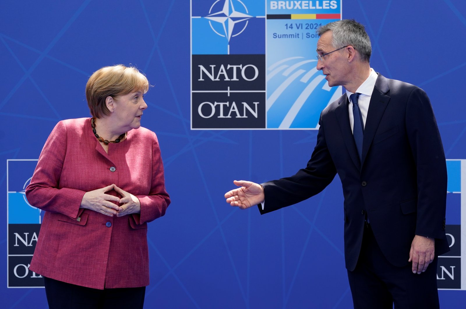 German Chancellor Angela Merkel (L) speaks with NATO Secretary-General Jens Stoltenberg as they pose for photos during the NATO summit at NATO headquarters in Brussels, Belgium, June 14, 2021. (Reuters Photo)