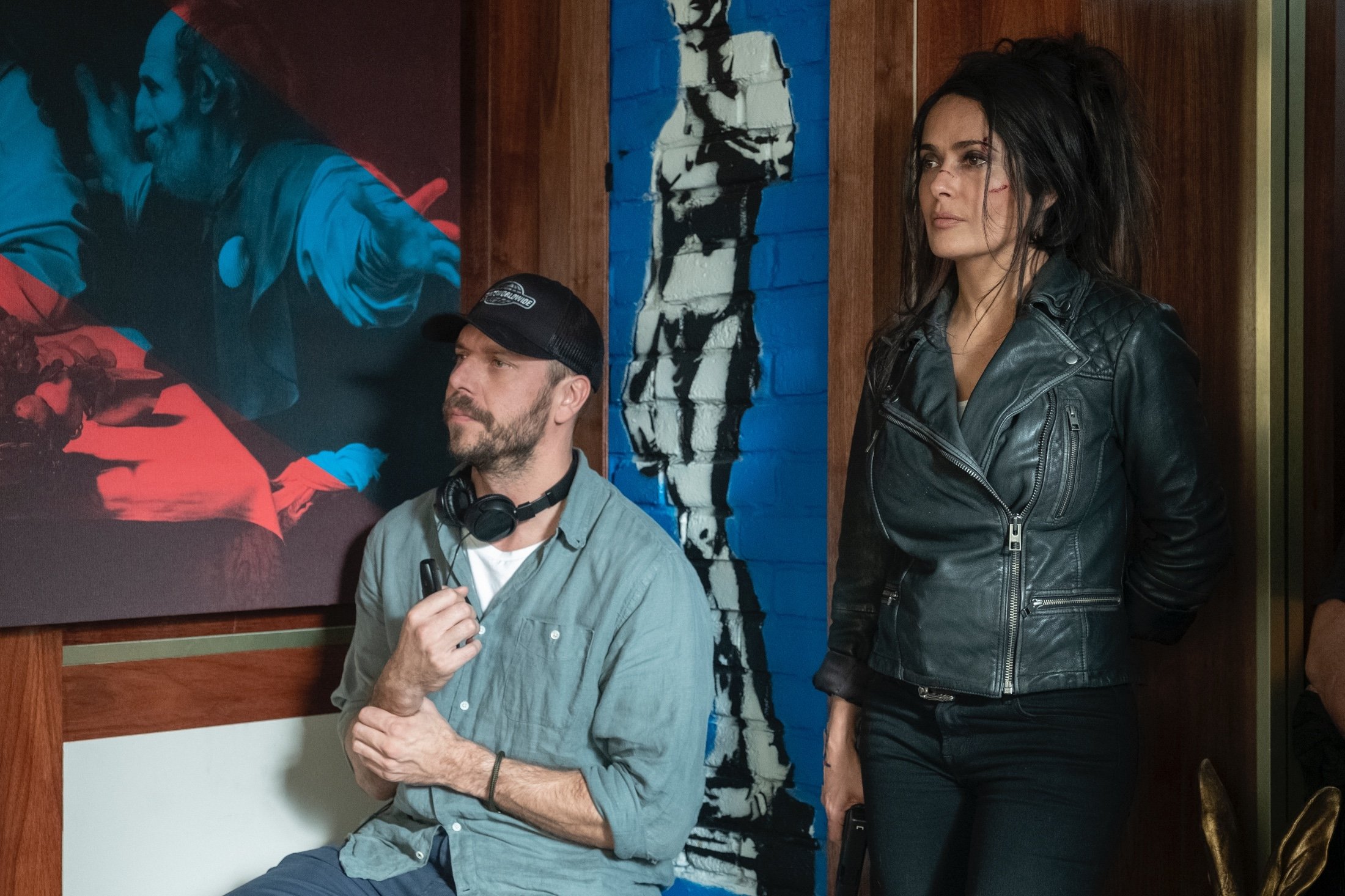 Salma Hayek (R) stands next to director Patrick Hughes on the set of the movie, "The Hitman