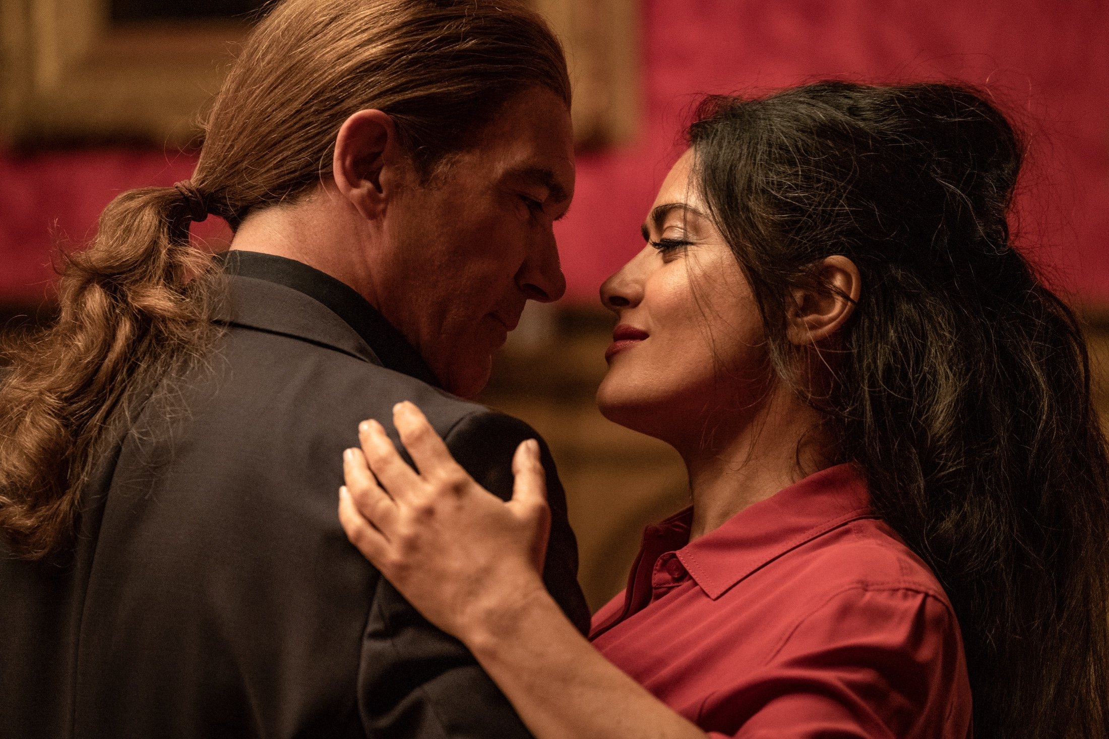Antonio Banderas (L) and Salma Hayek dance together, in a scene from the movie, "The Hitman