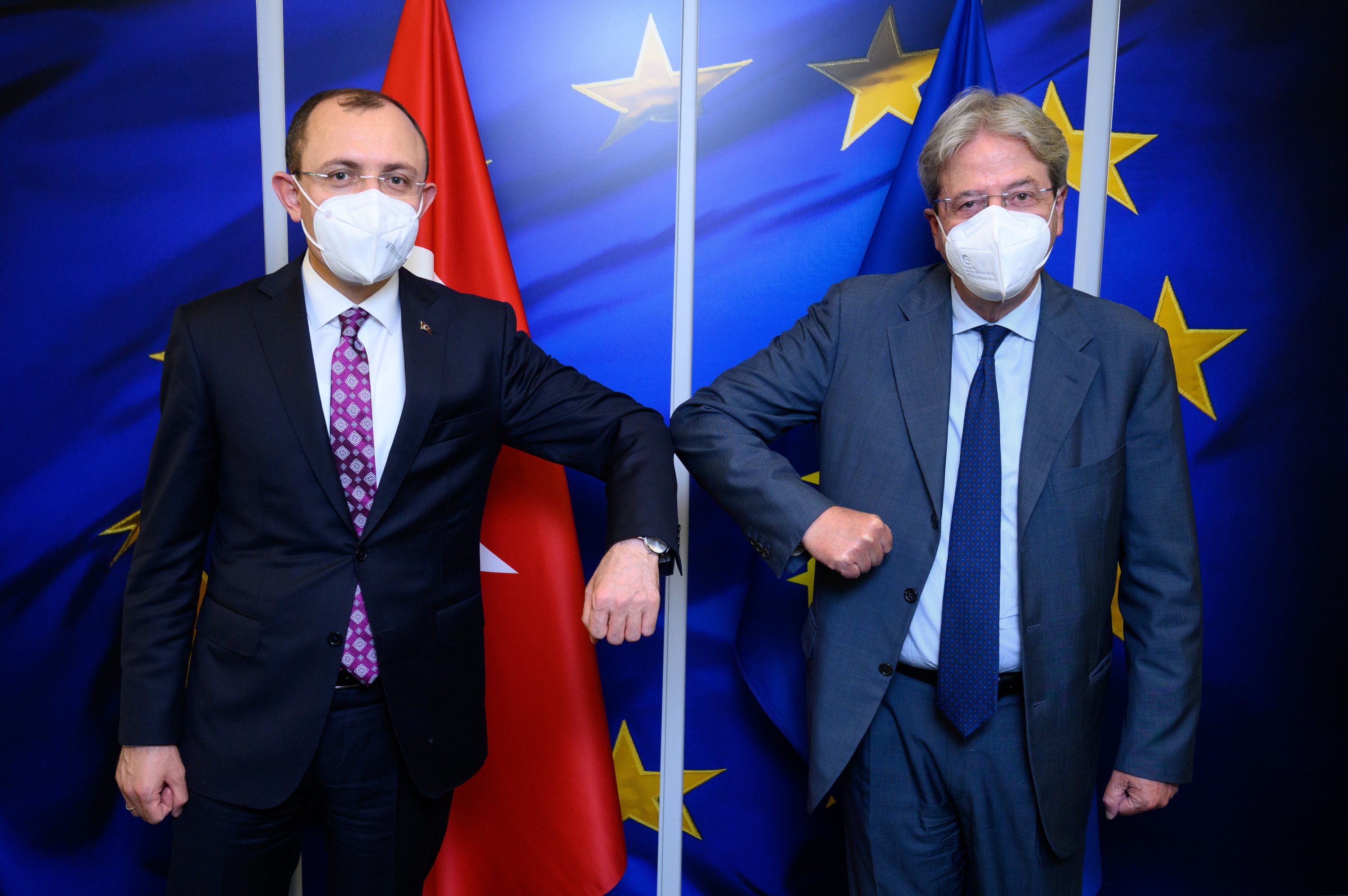 Trade Minister Mehmet Muş (L) and EU Commissioner for Economy Paolo Gentiloni elbow bump as they meet in Brussels, Belgium, June 14, 2021. (European Commission via AA)