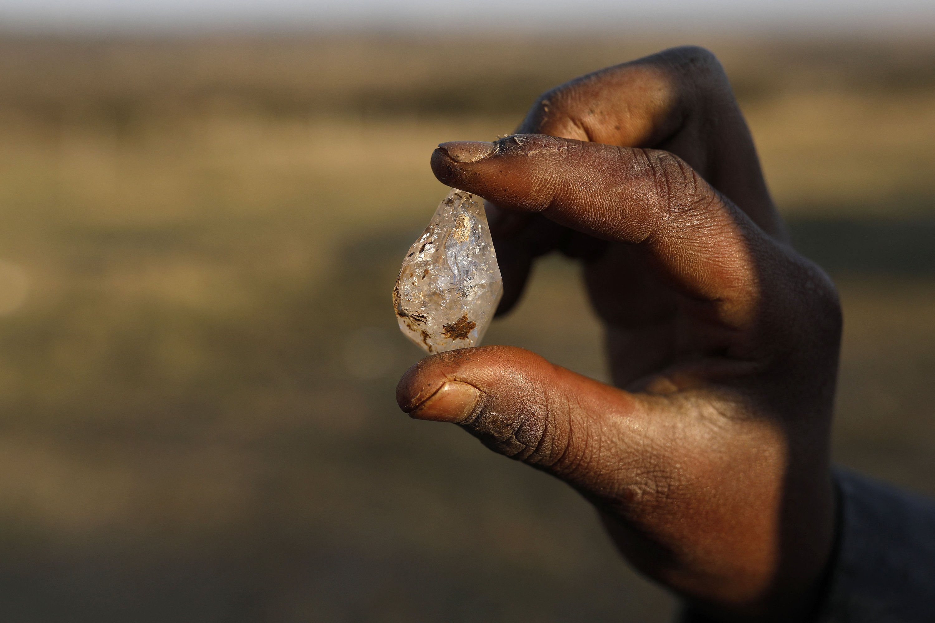 A boy holds what he believes to be a diamond in KwaHlathi village near Ladysmith in KwaZulu Natal, South Africa, June 15, 2021. (AFP Photo)