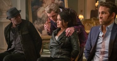 Antonio Banderas (C-L) has a conversation with Samuel L. Jackson (L), Salma Hayek (C-R) and Ryan Reynolds (R) in a scene from the movie, "The Hitman's Wife's Bodyguard." (Lionsgate via AP)