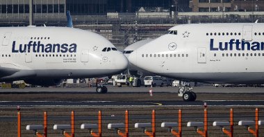 An Airbus A380 (L) and a Boeing 747, both from Lufthansa airlines, pass each other at the airport in Frankfurt, Germany, Feb.14, 2019. (AP Photo)