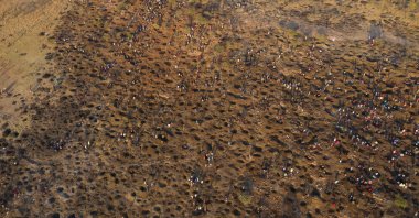 An aerial view shows people digging as they search for what they believe to be diamonds after the discovery of unidentified stones in KwaHlathi village near Ladysmith in KwaZulu Natal, South Africa, June 15, 2021. (AFP Photo)