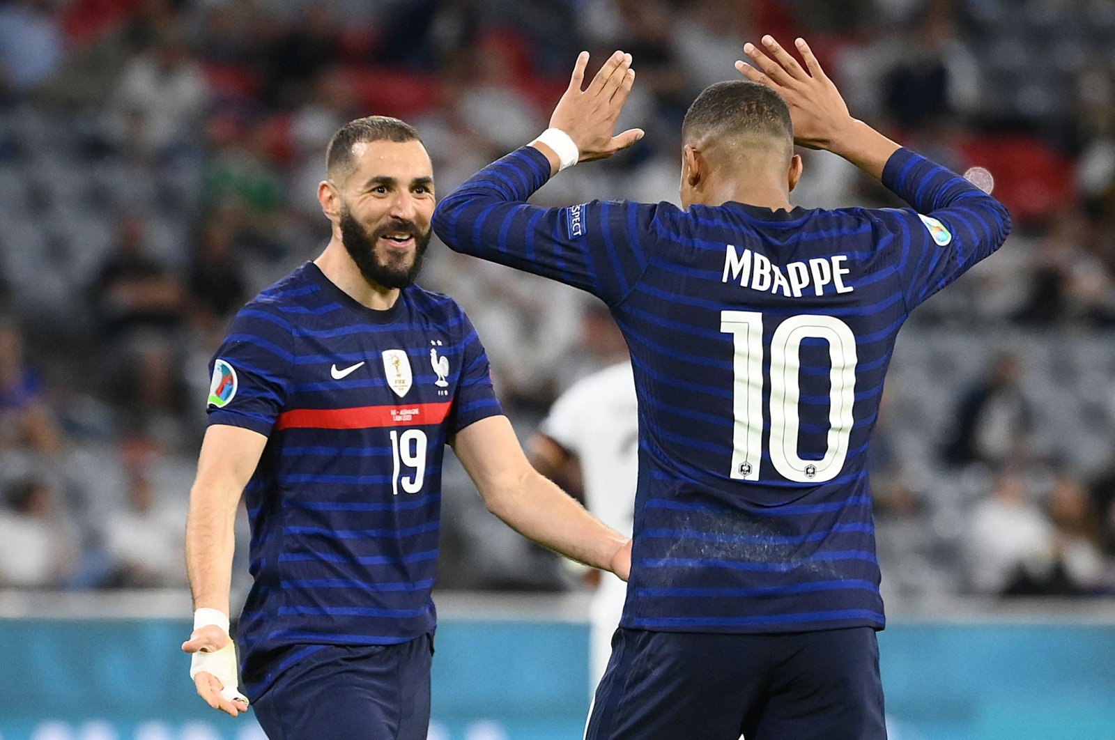 France's forward Karim Benzema (L) celebrates with France's forward Kylian Mbappe after scoring, before it was later revoked due to offside, during the UEFA EURO 2020 Group F football match between France and Germany at the Allianz Arena in Munich on June 15, 2021. (AFP Photo)