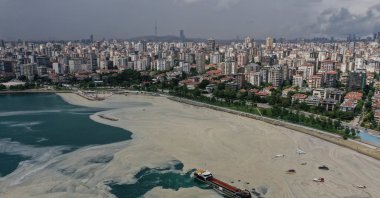 Sea surface cleaning vessels and barrier-laying boats of Istanbul Municipality clean up the sea snot, a thick slimy layer of organic matter also known as marine mucilage, spreading through the Marmara Sea and posing a threat to marine life and the fishing industry, in Istanbul, Turkey, June 15, 2021. (Reuters Photo)