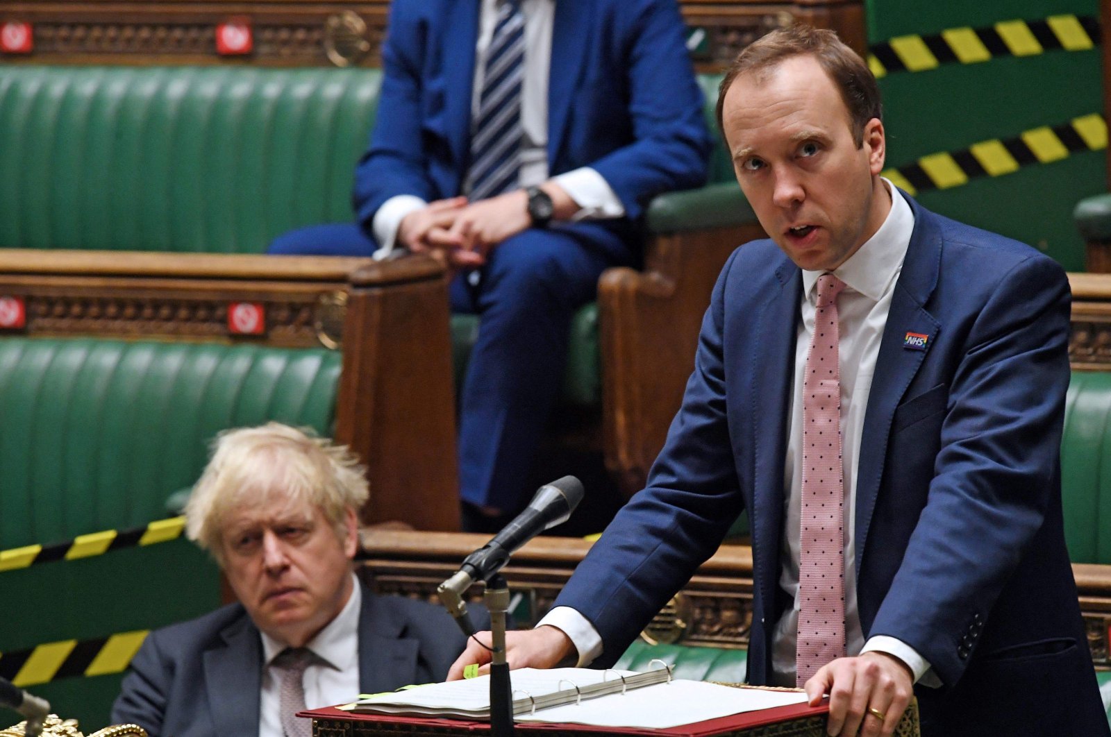 Britain's Prime Minister Boris Johnson (L) listens as Britain's Health Secretary Matt Hancock gives a COVID-19 update statement in the House of Commons in London, U.K., November 26, 2020. (AFP Photo)