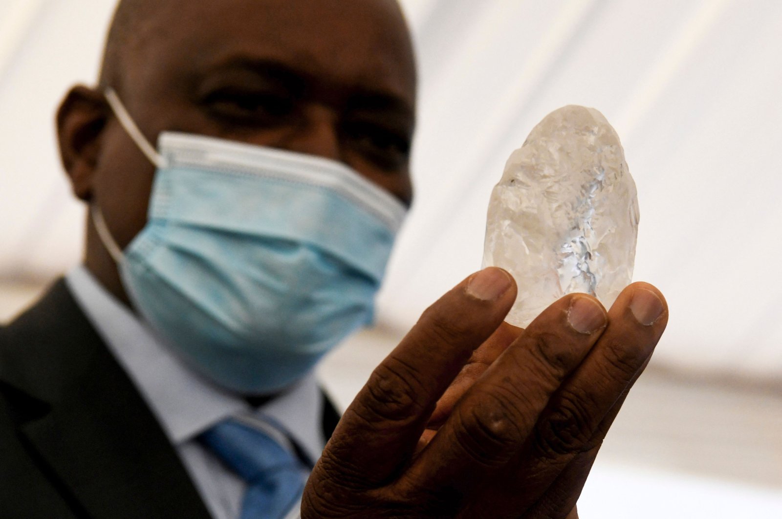 Botswana President Mokgweetsi Masisi holds a gem diamond in Gaborone, Botswana, on June 16, 2021. (AFP Photo)