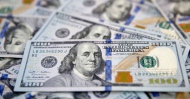 $100 bills fan out over each other in Dallas, Texas, the U.S., Jan. 22, 2020. (AP Photo)