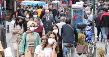 People wearing protective masks against COVID-19 walk on a street, in Eskişehir, central Turkey, May 19, 2021. (DHA PHOTO) 