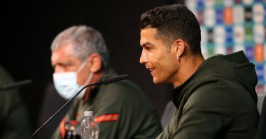 Portugal's forward Cristiano Ronaldo (R) and Portugal's coach Fernando Santos speak during a news conference at the Puskas Arena in Budapest, Hungary, June 14, 2021. (UEFA via AFP)