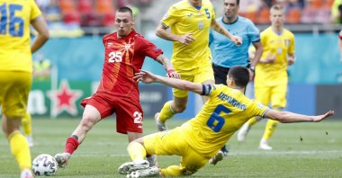 North Macedonia's Darko Churlinov battles for the ball with Ukraine's Taras Stepanenko (R) during the Euro 2020 soccer championship group C match between Ukraine and North Macedonia at the National Arena stadium in Bucharest, Romania, June 17, 2021. (AP Photo)