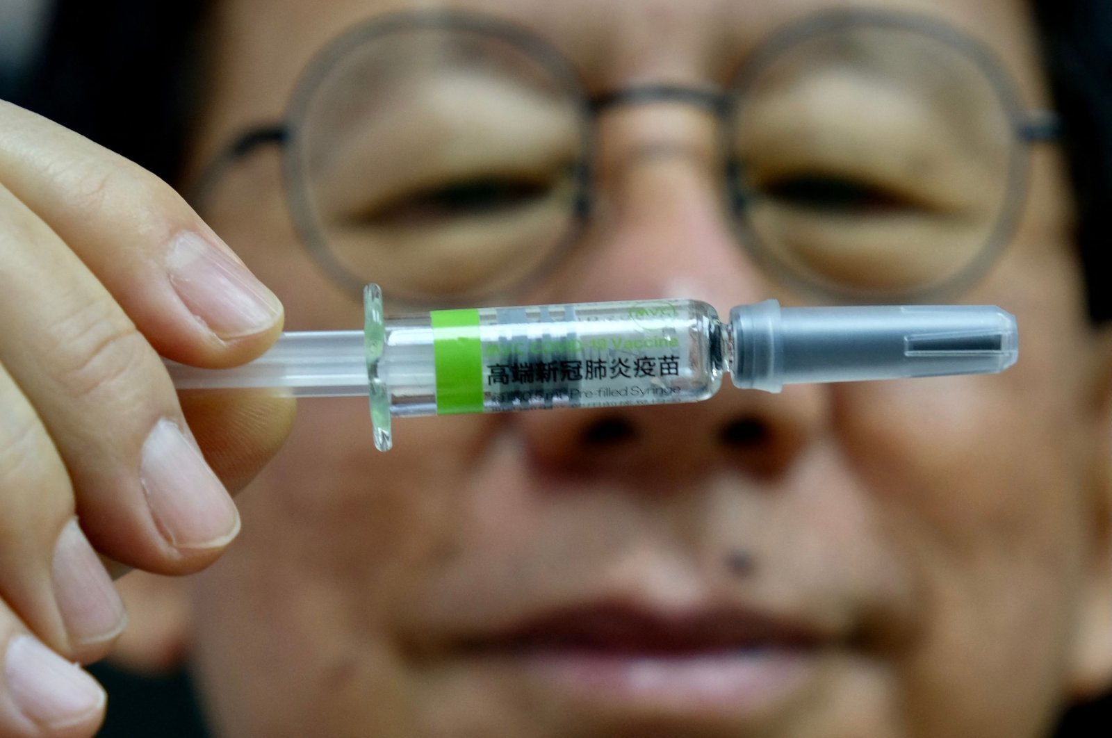 Charles Chen, Chief Executive Officer of Taiwan’s vaccine maker Medigen Vaccine Biologics Corp (MVC), poses for photographs with a vaccine sample at its headquarters in Taipei, Taiwan, on June 16, 2021. (AFP Photo)