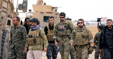YPG terrorists and U.S. troops are seen together during a joint patrol near the Turkish border in Hassakeh, northeastern Syria, Nov. 4, 2018. (Reuters Photo)