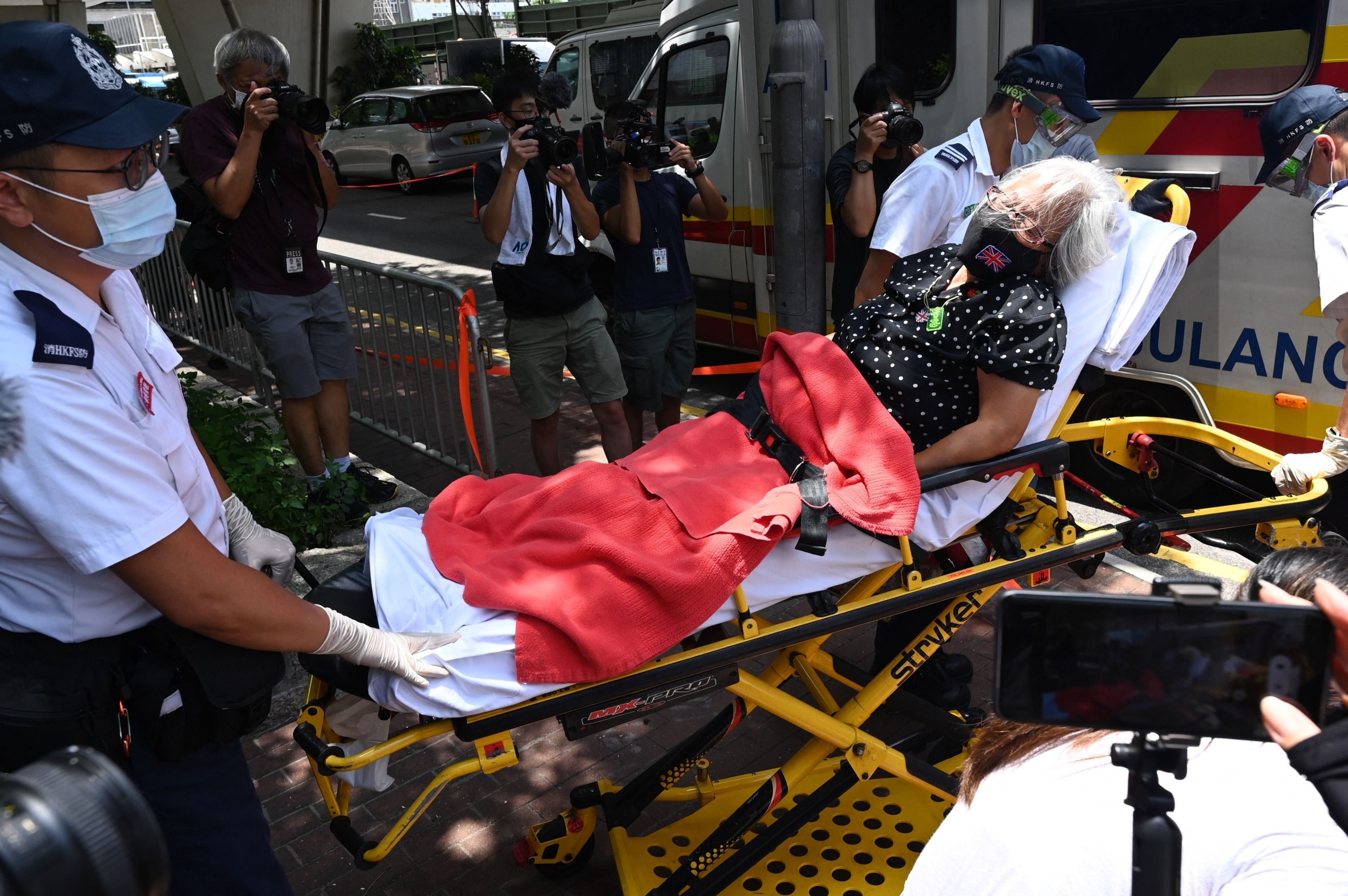 Activist Alexandra Wong, also known as Grandma Wong, is taken to an ambulance after falling ill outside the court in Hong Kong, China, June 19, 2021. (AFP Photo)