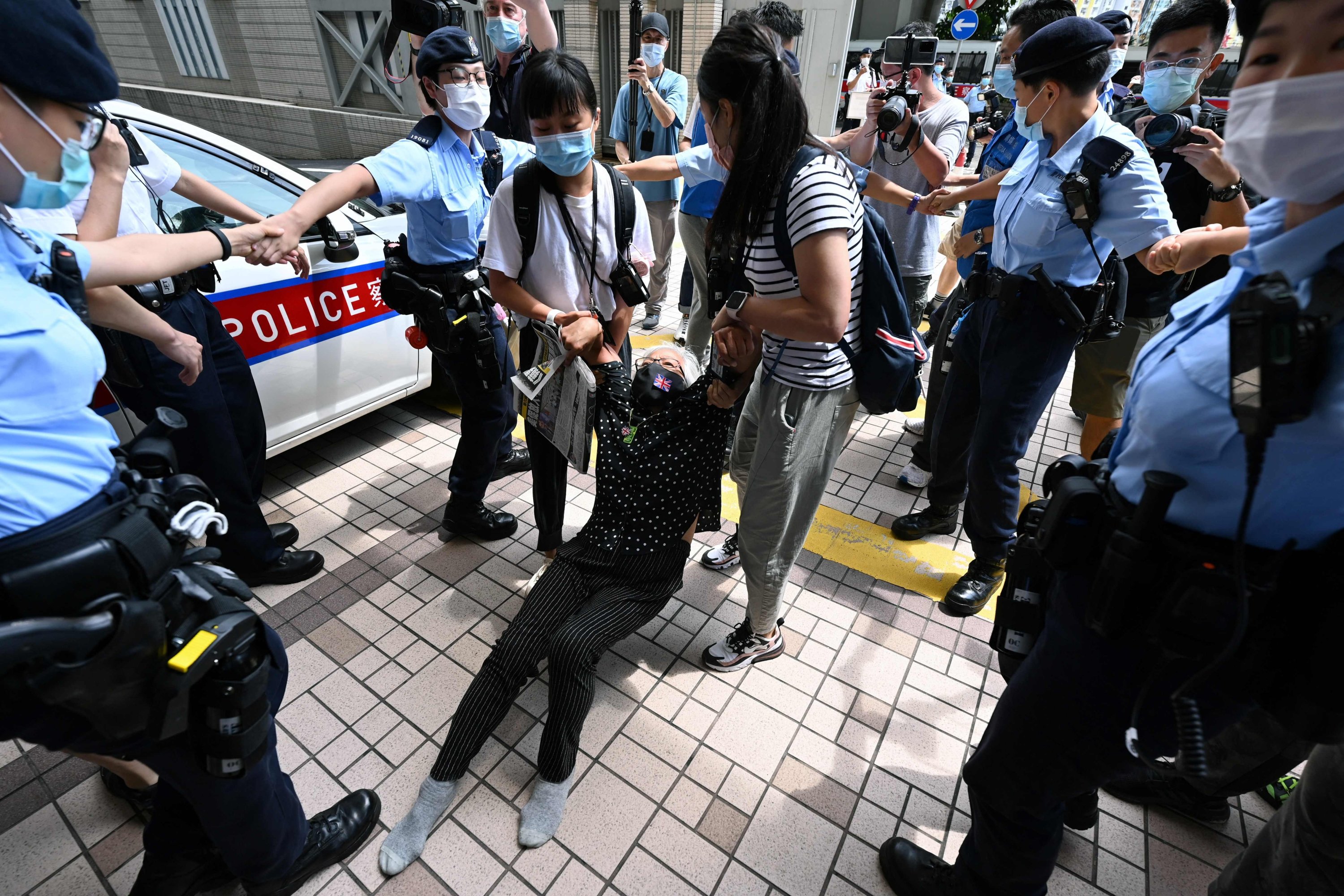 Activist Alexandra Wong (C), also known as Grandma Wong, is dragged away by police inside the court grounds in Hong Kong, China, June 19, 2021. (AFP Photo)
