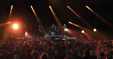 Festivalgoers watch Death Blooms on stage on the first day of the Download Festival at Donington Park at Castle Donington, England, June 18, 2021. (Joe Giddens via AP)