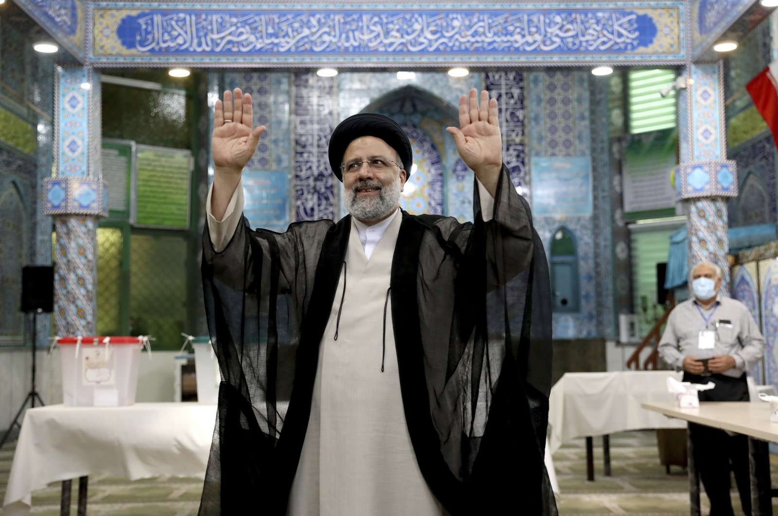 Ebrahim Raisi, a candidate in Iran's presidential elections waves to the media after casting his vote at a polling station in Tehran, Iran, June 18, 2021. (AP Photo)