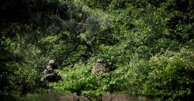 Soldiers search for Jurgen Conings, a heavily armed Belgian soldier with far-right views, in Nationaal Park Hoge Kempen in Maasmechelen, Belgium, on June 4, 2021. (AFP Photo)