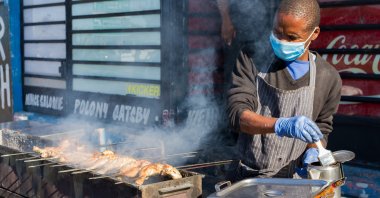African street food vendor wearing a protective mask in Cape Town, South Africa, June 2020. (Shutterstock Photo) 