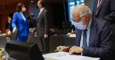 European Union foreign policy chief Josep Borrell (R) looks at his papers as Belarusian opposition politician Sviatlana Tsikhanouskaya (L) talks to Greek Cypriot administration spokesperson Nicos Christodoulides during a European Foreign Affairs Ministers meeting at the European Council building in Luxembourg, June 21, 2021.(AP Photo)