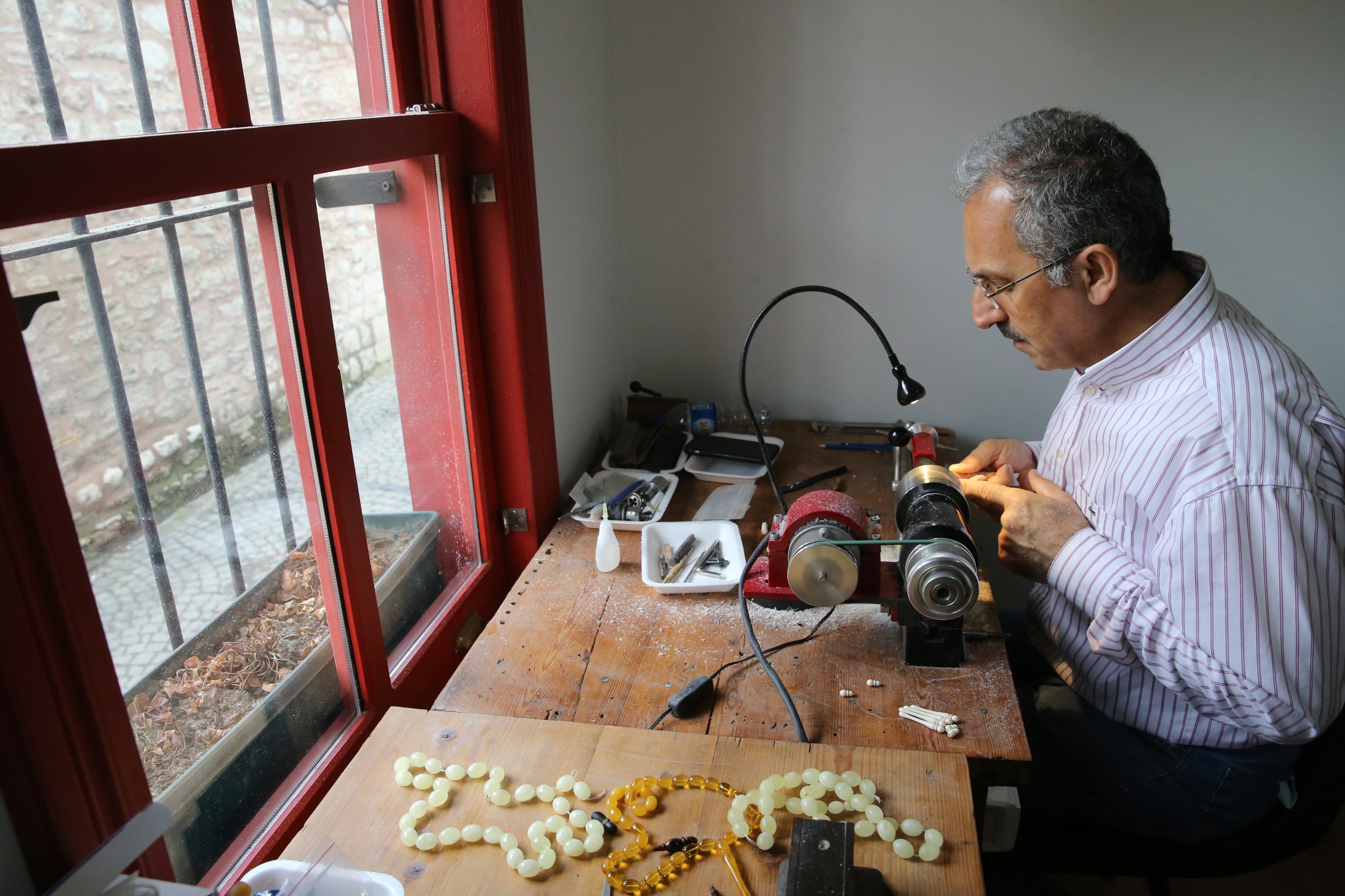 Imdat Kalaycı works on tesbihs in his workshop in Istanbul, Turkey, June 21, 2021. (AA Photo)