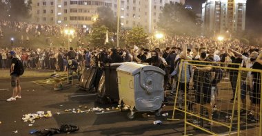 Protesters try to set up a barricade during clashes with police after the Belarusian presidential election in Minsk, Belarus, Aug. 9, 2020. (AP Photo)