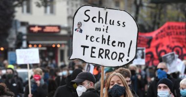 A rally against neo-Nazis where a woman holds a sign reading "end to right terror," Berlin, Germany, Nov. 7, 2020. (Reuters Photo)