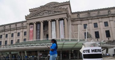 A woman walks past the Brooklyn Museum polling station as residents vote in the Democratic mayoral primary election, New York City, United States, June 22, 2021. (AFP Photo)