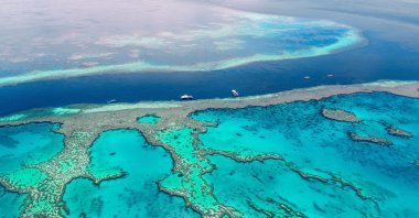 Boats float at the Great Barrier Reef. (Shutterstock Photo)