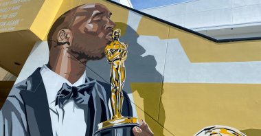 A mural by artist Brian Peterson shows late LA Lakers icon Kobe Bryant holding his Oscar, won in 2018 for Best Animated Short Film “Dear Basketball,” in the Dolby theater complex in Los Angeles, U.S., June 17, 2021. (AFP Photo)