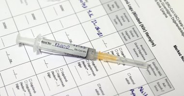 A syringe filled with Turkovac rests on a chart at a laboratory, in the capital Ankara, Turkey, June 22, 2021. (AA PHOTO)