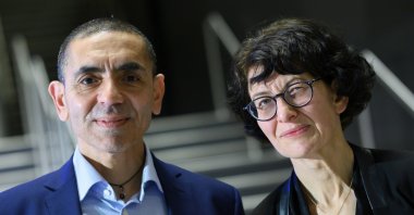 Uğur Şahin (L) and Özlem Türeci pose for a photo at an award ceremony, in Berlin, Germany, March 18, 2021. (AP PHOTO) 