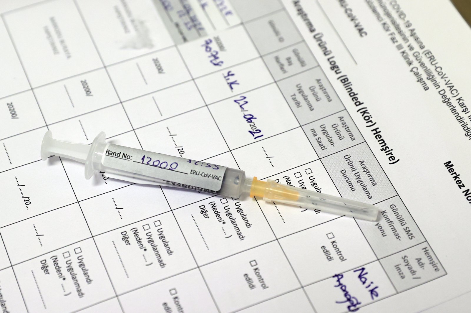 A syringe filled with Turkovac rests on a chart at a laboratory, in the capital Ankara, Turkey, June 22, 2021. (AA PHOTO)