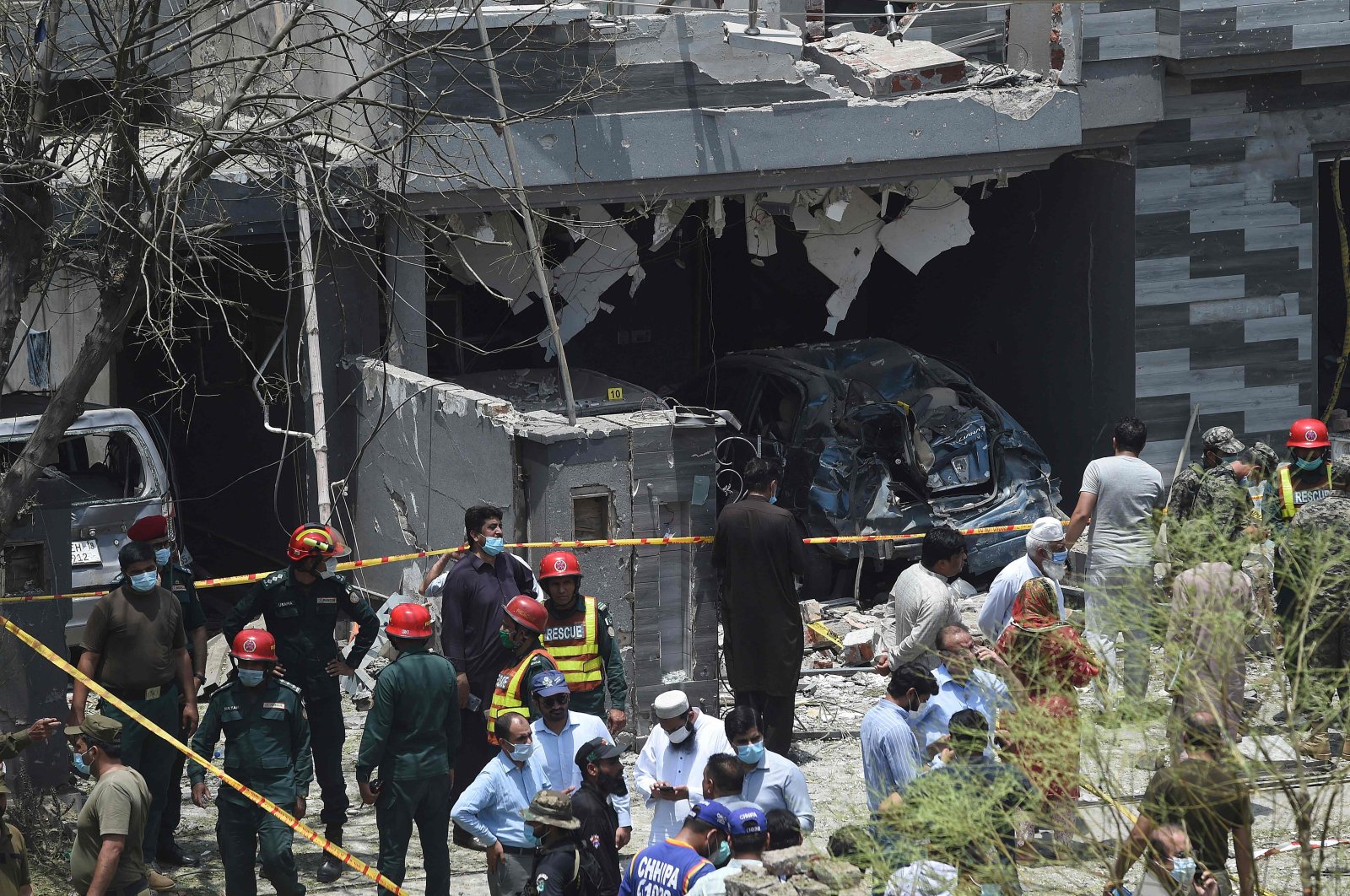 Security officials inspect the site of an explosion that killed at least three people and wounded several others in the city of Lahore, eastern Pakistan, June 23, 2021. (AFP Photo)