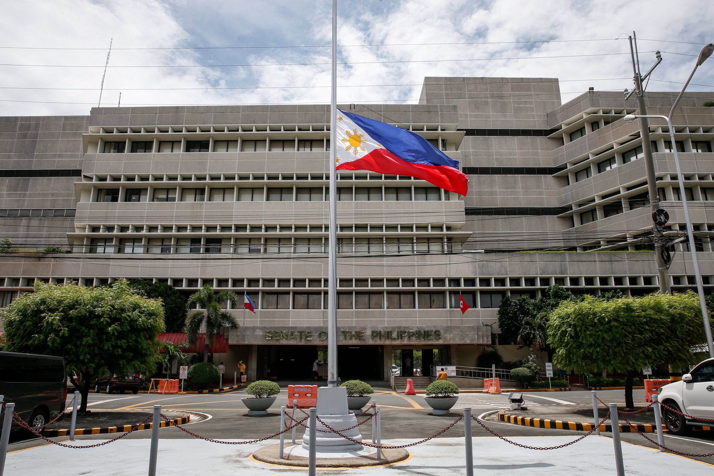 The Philippine flag flies at half-mast to mourn the death of former President Benigno Aquino III, outside the Senate in Manila, Philippines, June 24, 2021. (EPA Photo)