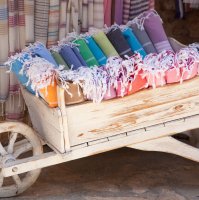 Multicolored Turkish bath towels in a wooden cart. (Shutterstock Photo)