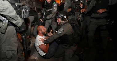 A Palestinian protester is detained during clashes with Israeli police, as the Muslim holy fasting month of Ramadan continues, in Jerusalem, April 23, 2021. (Reuters Photo)