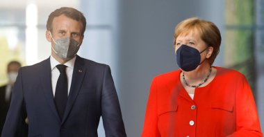 German Chancellor Angela Merkel and French President Emmanuel Macron arrive to address a press statement ahead of talks at the Chancellery in Berlin, Germany, June 18, 2021. (AFP Photo)