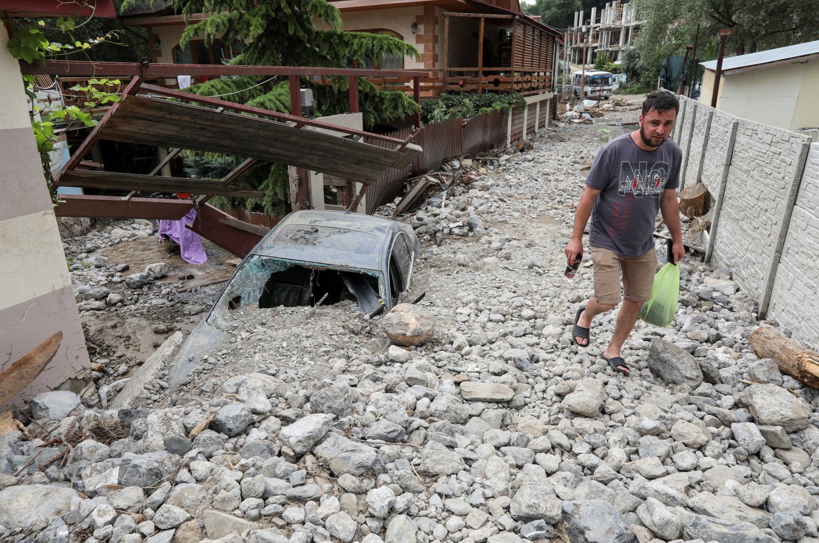A man walks along a damaged street after heavy rainfall and floods in Yalta, Crimea, June 22, 2021. (Reuters Photo)