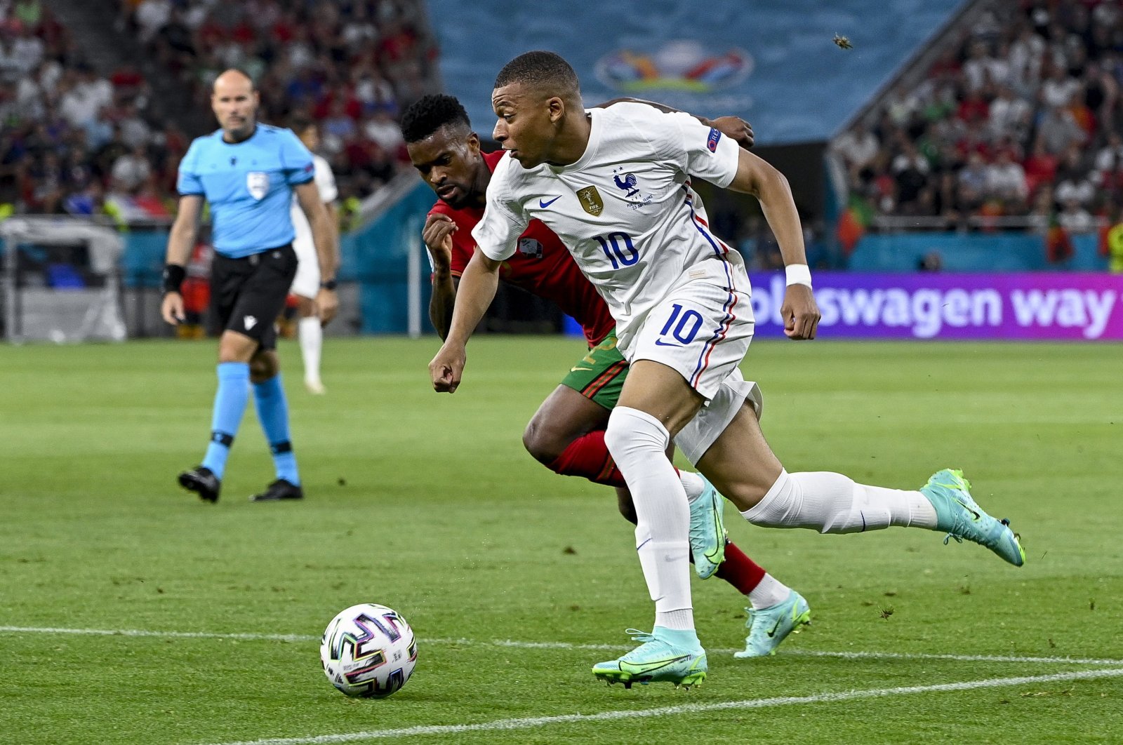 France's Kylian Mbappe (R) is challenged by Portugal's Nelson Semedo (L) for the ball during their Euro 2020 Group F match at Puskas Arena in Budapest, Hungary, June 23, 2021. (EPA Photo)