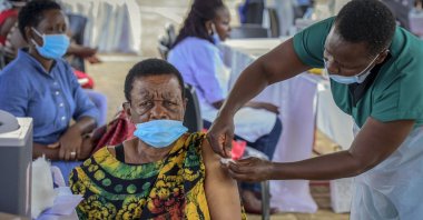 A woman receives a coronavirus vaccine shot at the Kololo airstrip in Kampala, Uganda, May 31, 2021. (AP Photo)