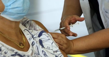 A woman gets a shot of the Pfizer-BioNTech vaccine at a vaccination center in Capbreton, in the Landes region, southwestern France, June 24, 2021. (AP Photo)