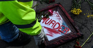 City workers clear out flowers and mirrors placed on the road as part of an art installation outside the Hennepin County Government Center after the first day of jury selection began in the trial of former Minneapolis Police officer Derek Chauvin in Minneapolis, Minnesota, U.S., March 8, 2021. (AFP Photo)