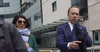 Aide Gina Coladangelo (L) walks with Britain's Health Secretary Matt Hancock outside BBC Broadcasting House, London, U.K., May 16, 2021. (AP Photo)