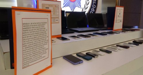 Police display cellphones, computers and transcripts of exchanges between suspected gang members and victims, Istanbul, Turkey, June 25, 2021. (İHA PHOTO)