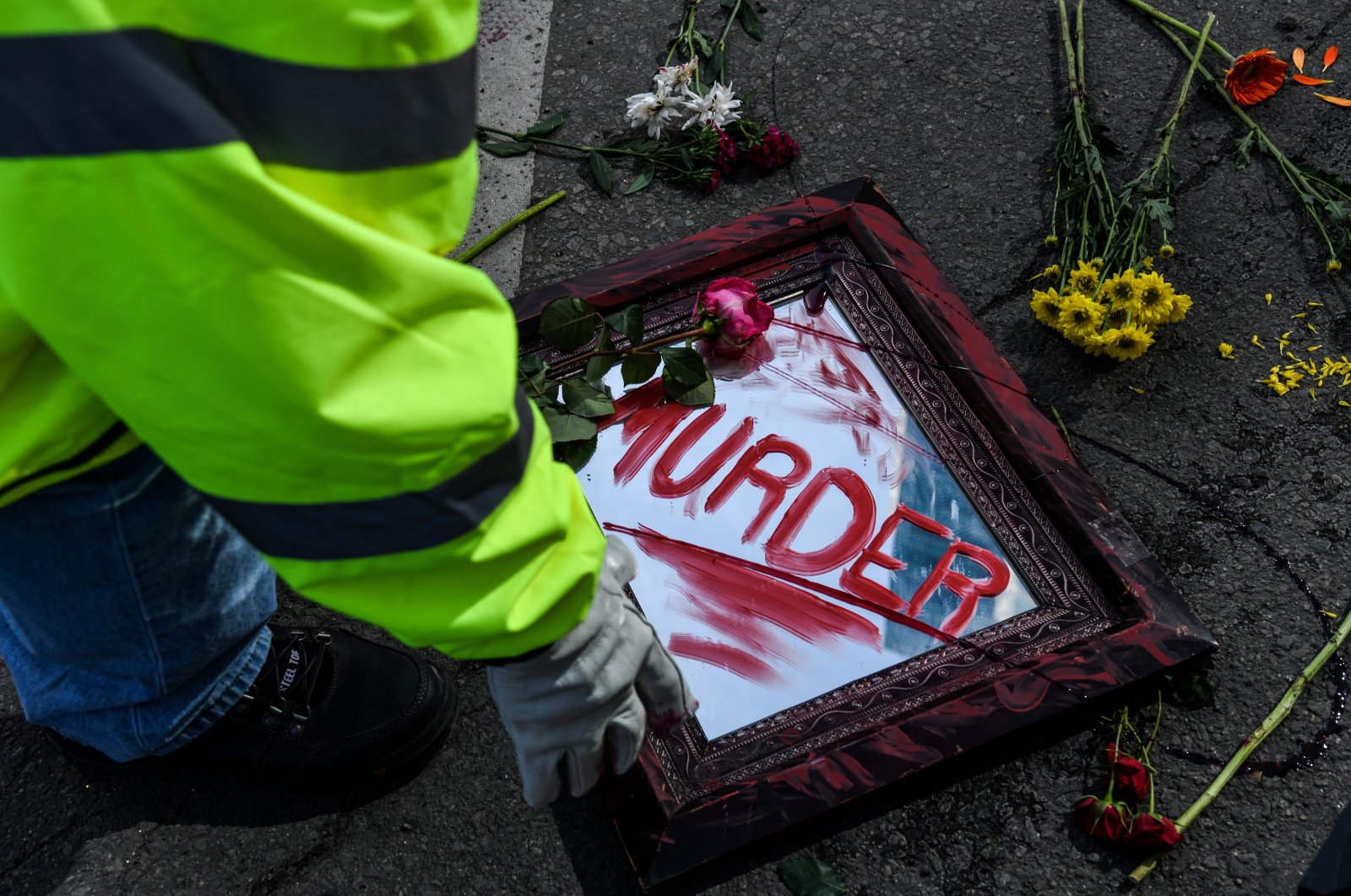City workers clear out flowers and mirrors placed on the road as part of an art installation outside the Hennepin County Government Center after the first day of jury selection began in the trial of former Minneapolis Police officer Derek Chauvin in Minneapolis, Minnesota, U.S., March 8, 2021. (AFP Photo)