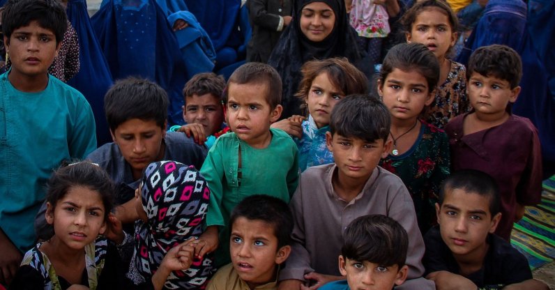 Children from internally displaced Afghan families arriving from the districts of Khan Abad, Ali Abad and Imam Sahib who fled from ongoing battles between Taliban and Afghan security forces, look on inside the premises of a school in Kunduz city, Afghanistan, June 26, 2021. (AFP Photo)